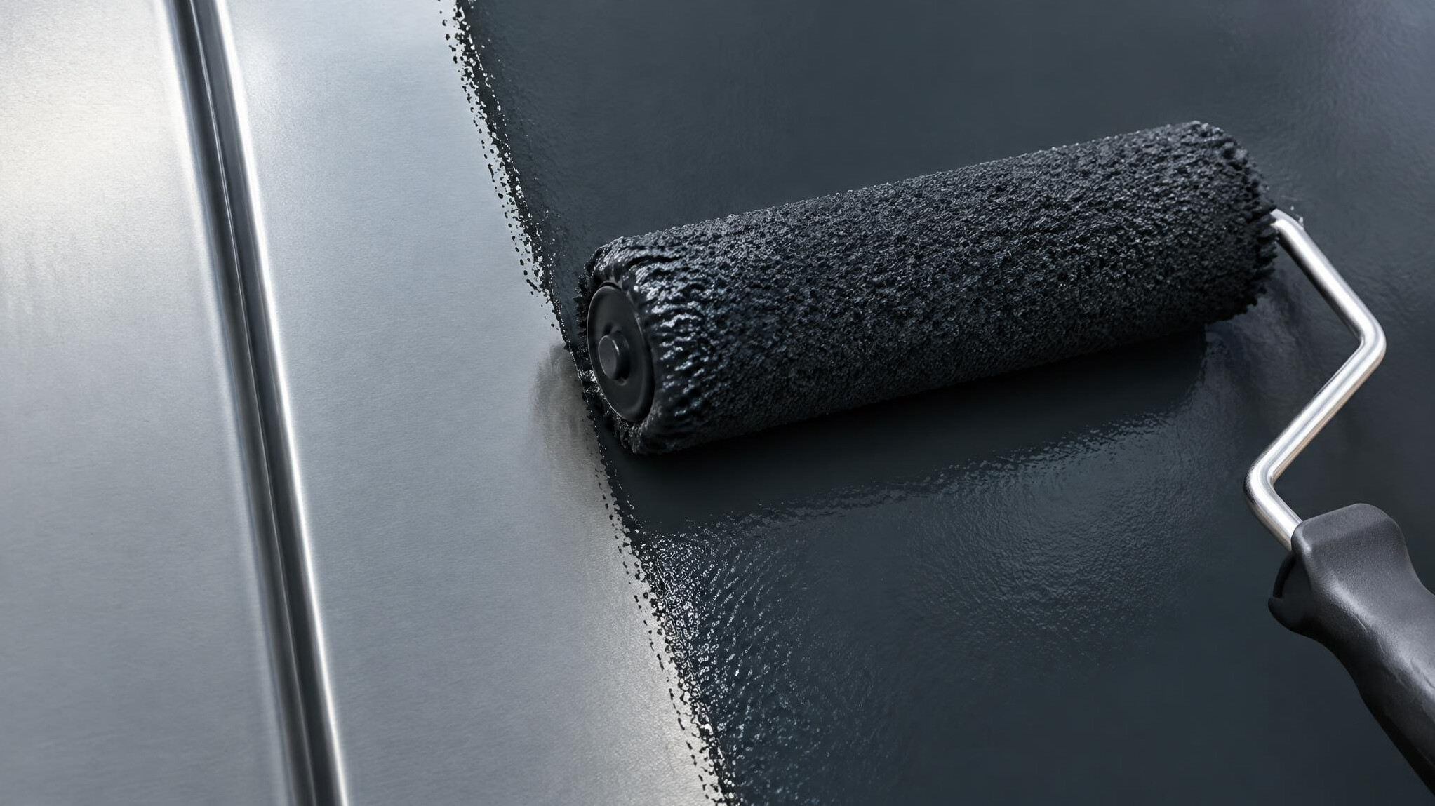 Paint roller applying a protective coat on a surface